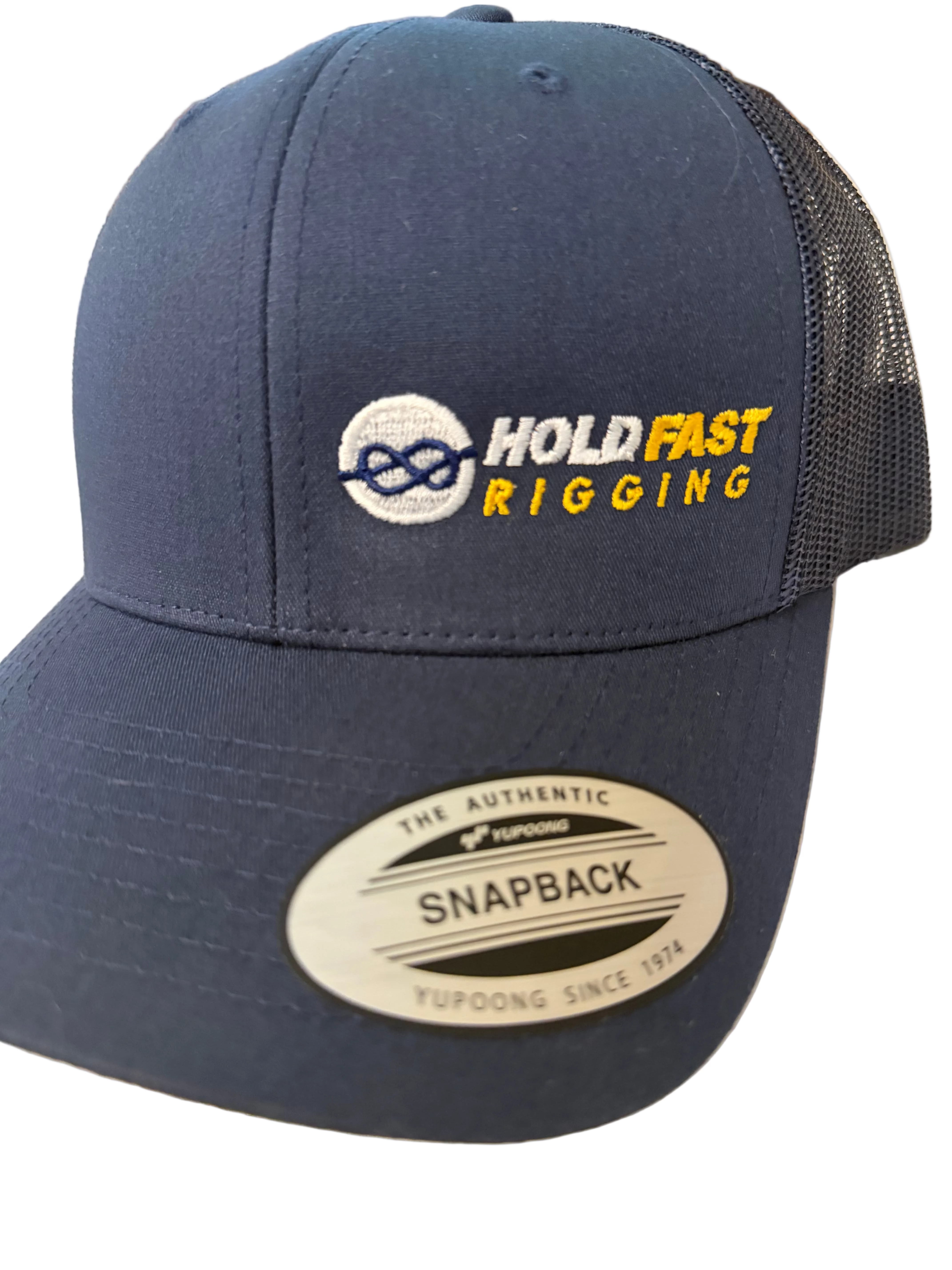 Navy blue cap with 'Hold Fast Rigging' logo on a light background